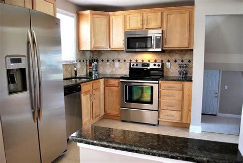 stainless steel appliance in light or dark wood cabinets|kitchen with dark cabinets.